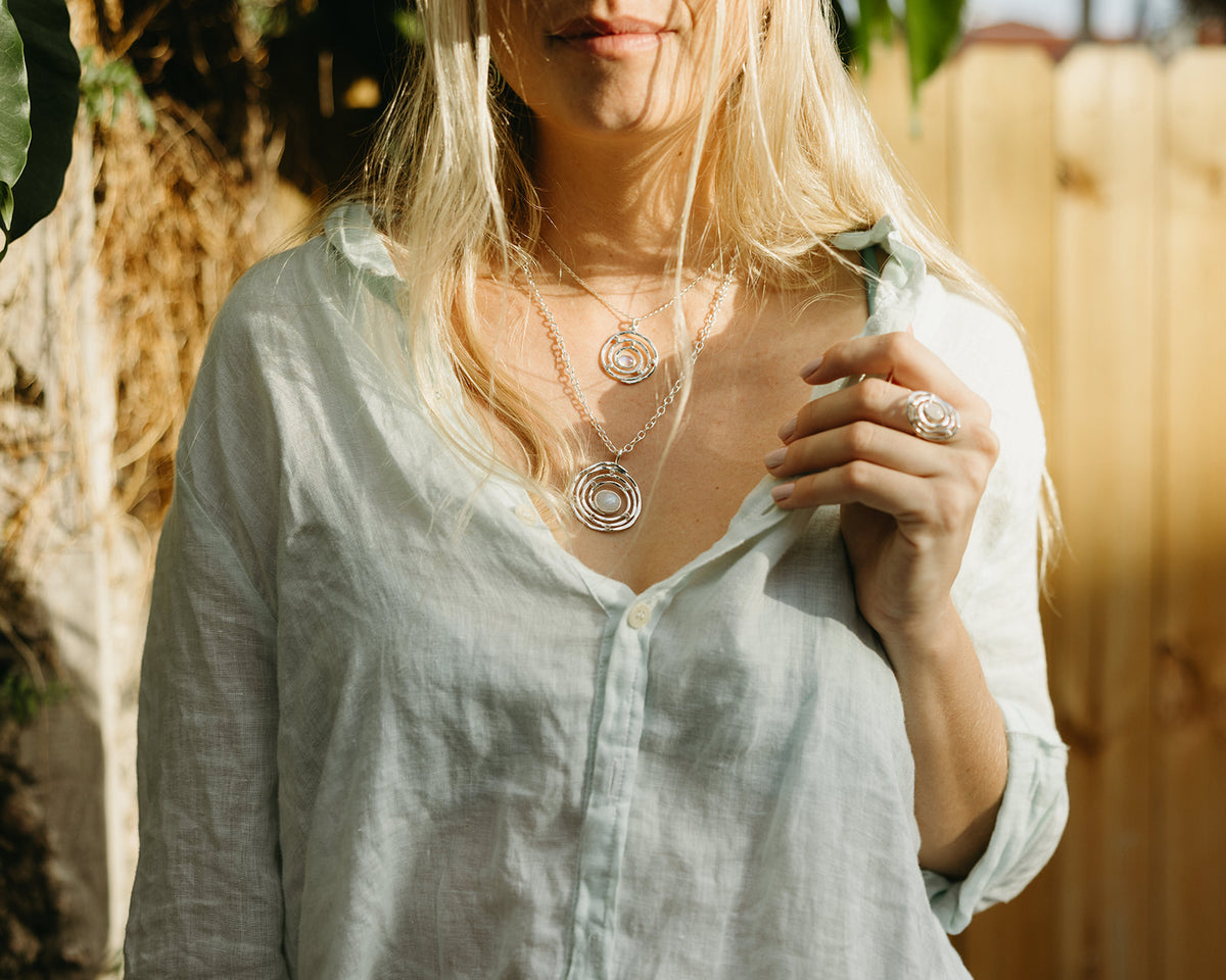 Lifestyle photo of the silver Eye of the Storm moonstone pendant