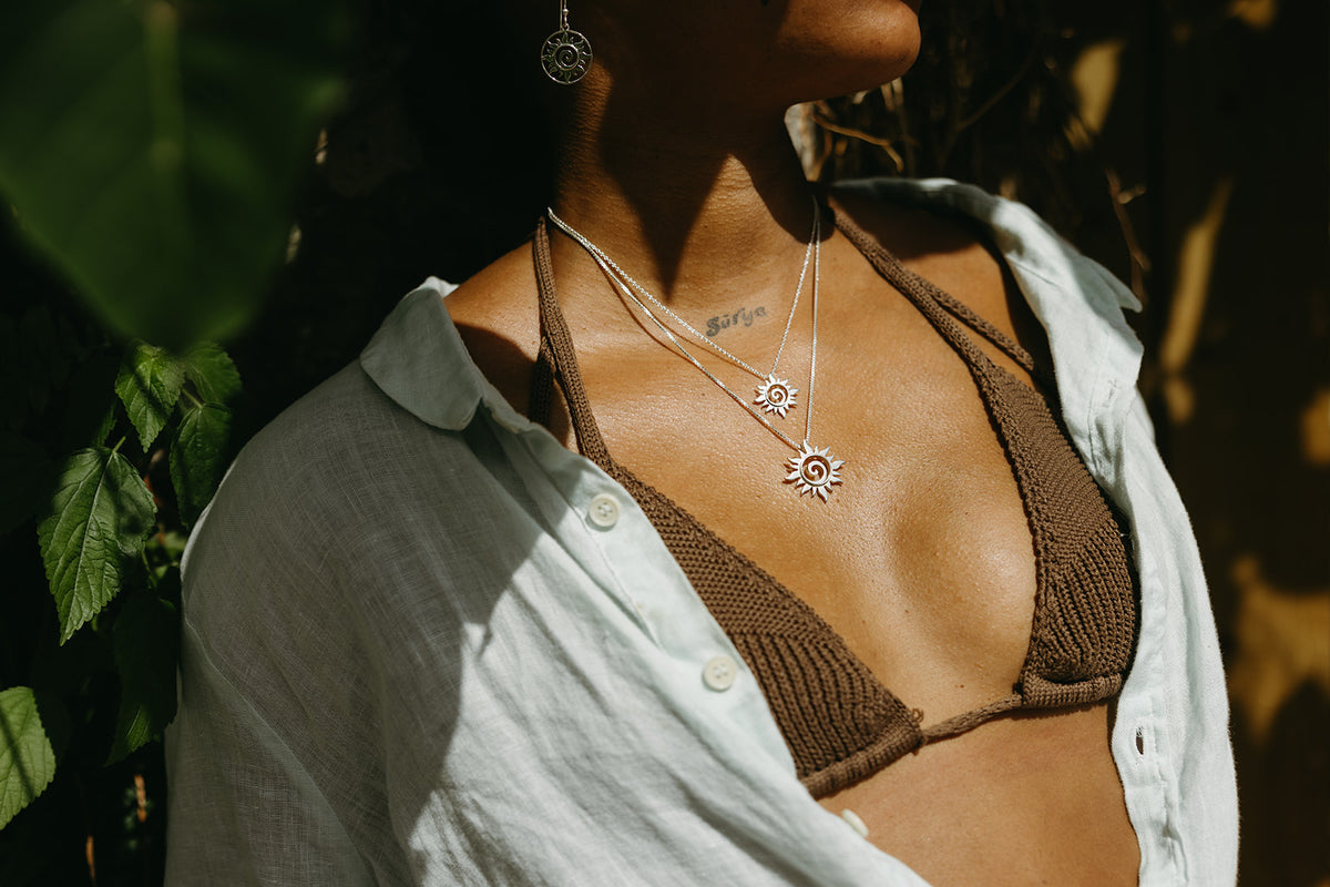 Lifestyle photo of the silver sun swirl pendant necklace