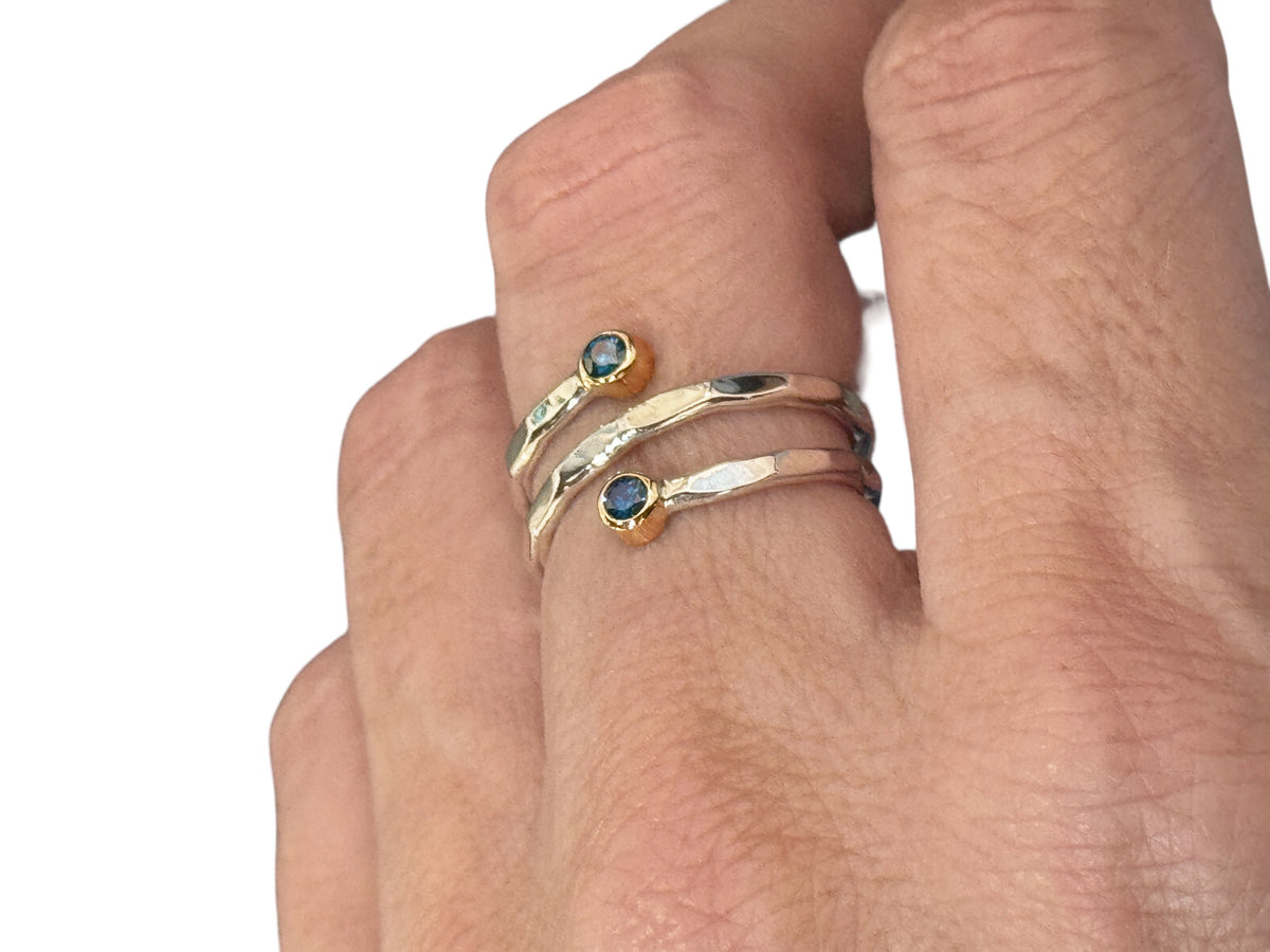 Side view of the silver and gold spiral ring showing its faceted band texture
