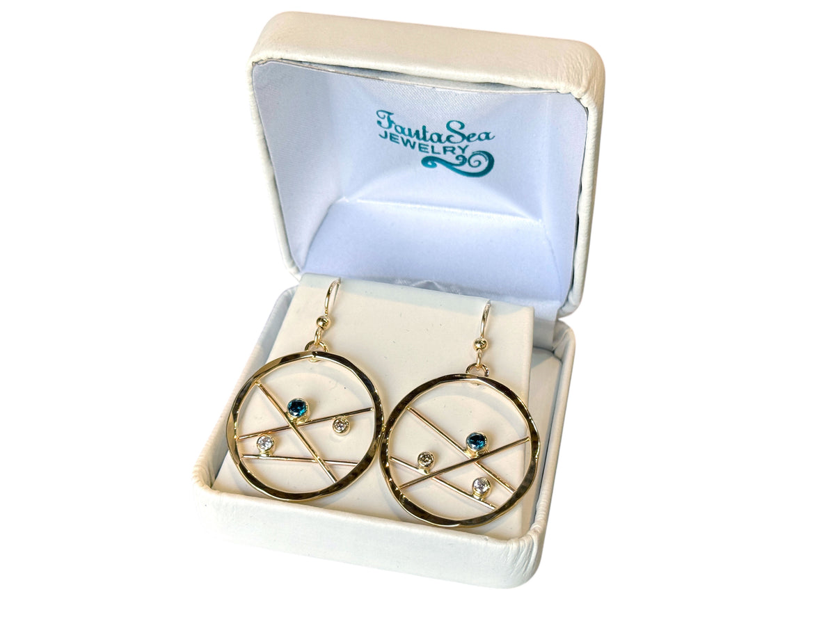 Close view of a gold gem catcher hoop showing its diamond accents