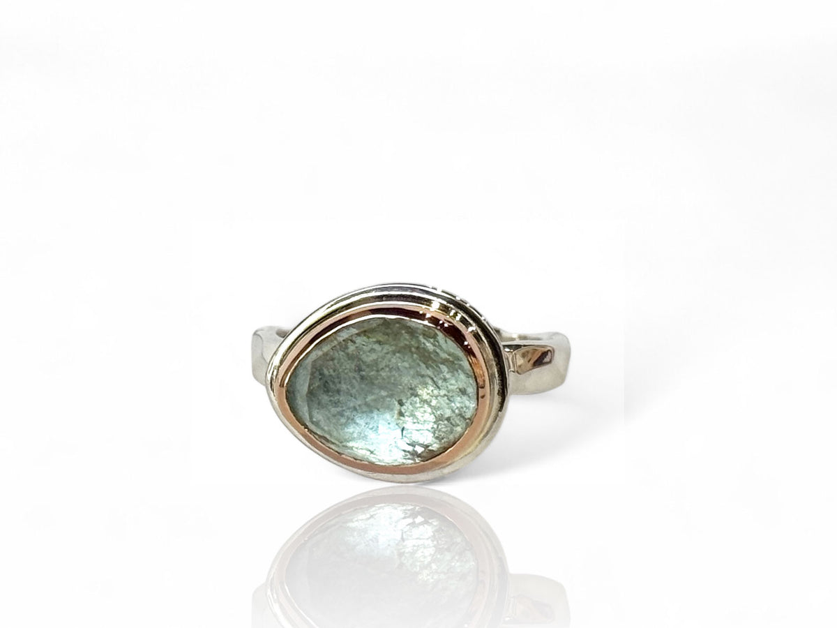 Alternate view of the freeform aquamarine ring in silver and rose gold