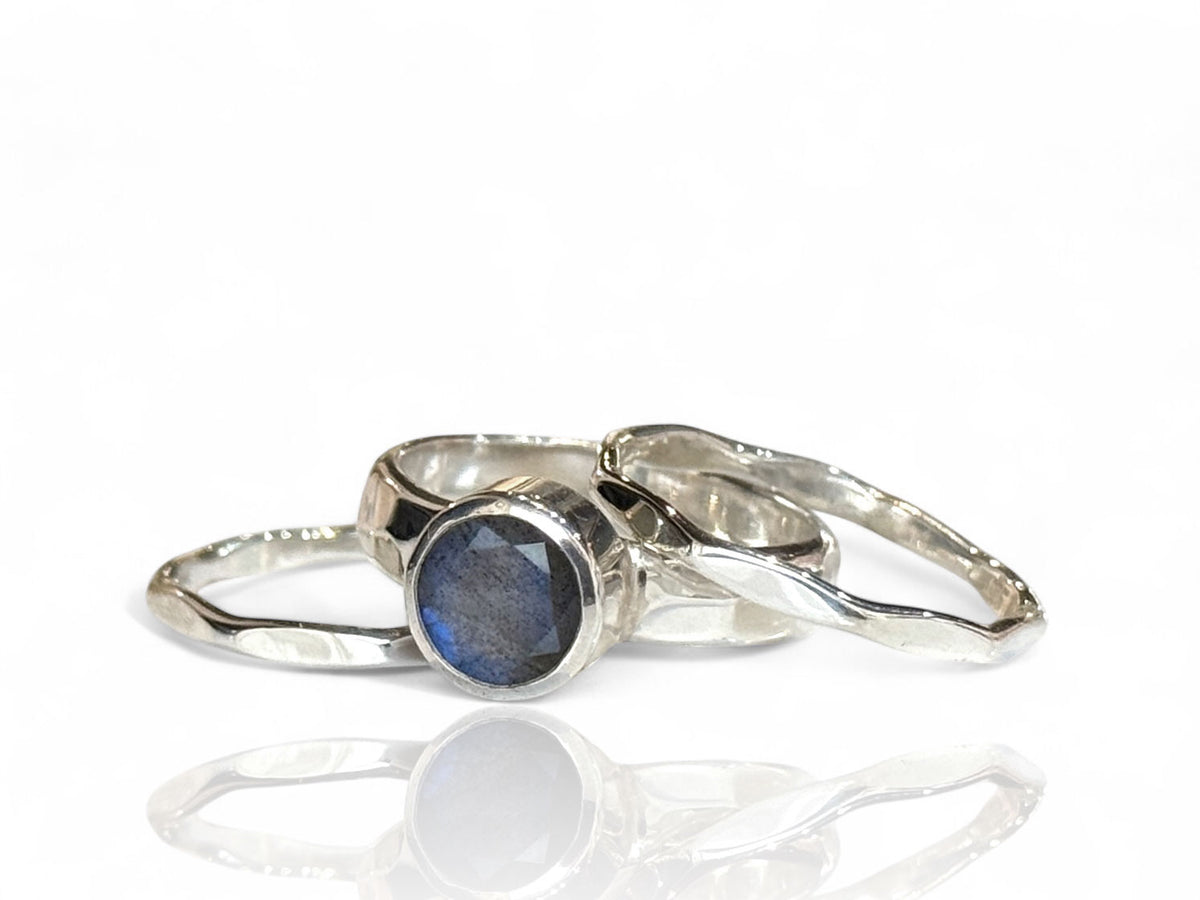 8mm round faceted labradorite on a wide hammered sterling silver band with matching silver stack bands