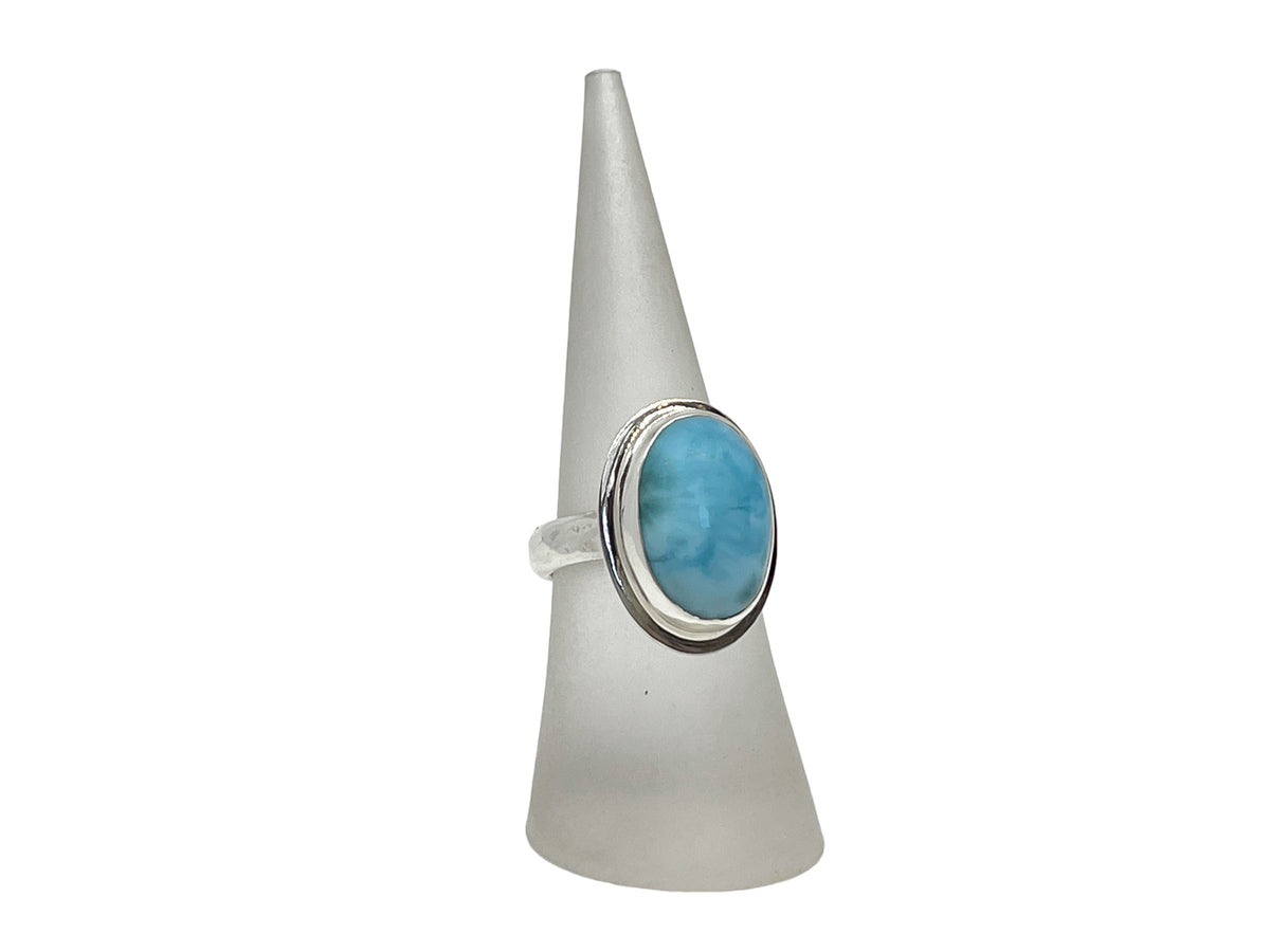 Side view of the oval larimar ring showing its 4.5mm hammered band