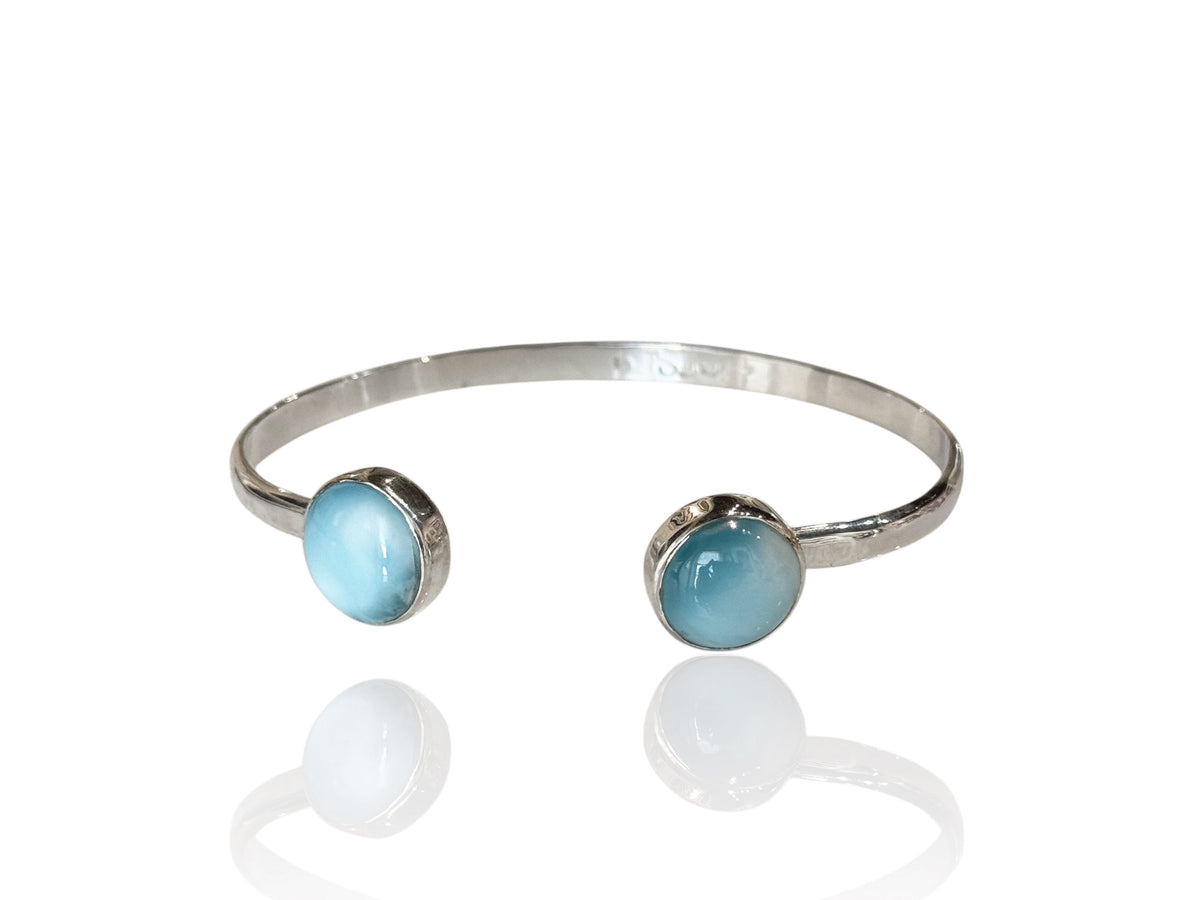 Close-up of the round larimar stones on the hammered silver cuff