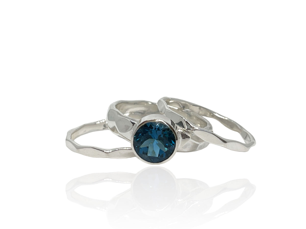 2.50-carat London blue topaz on a wide hammered sterling silver band with matching stack bands