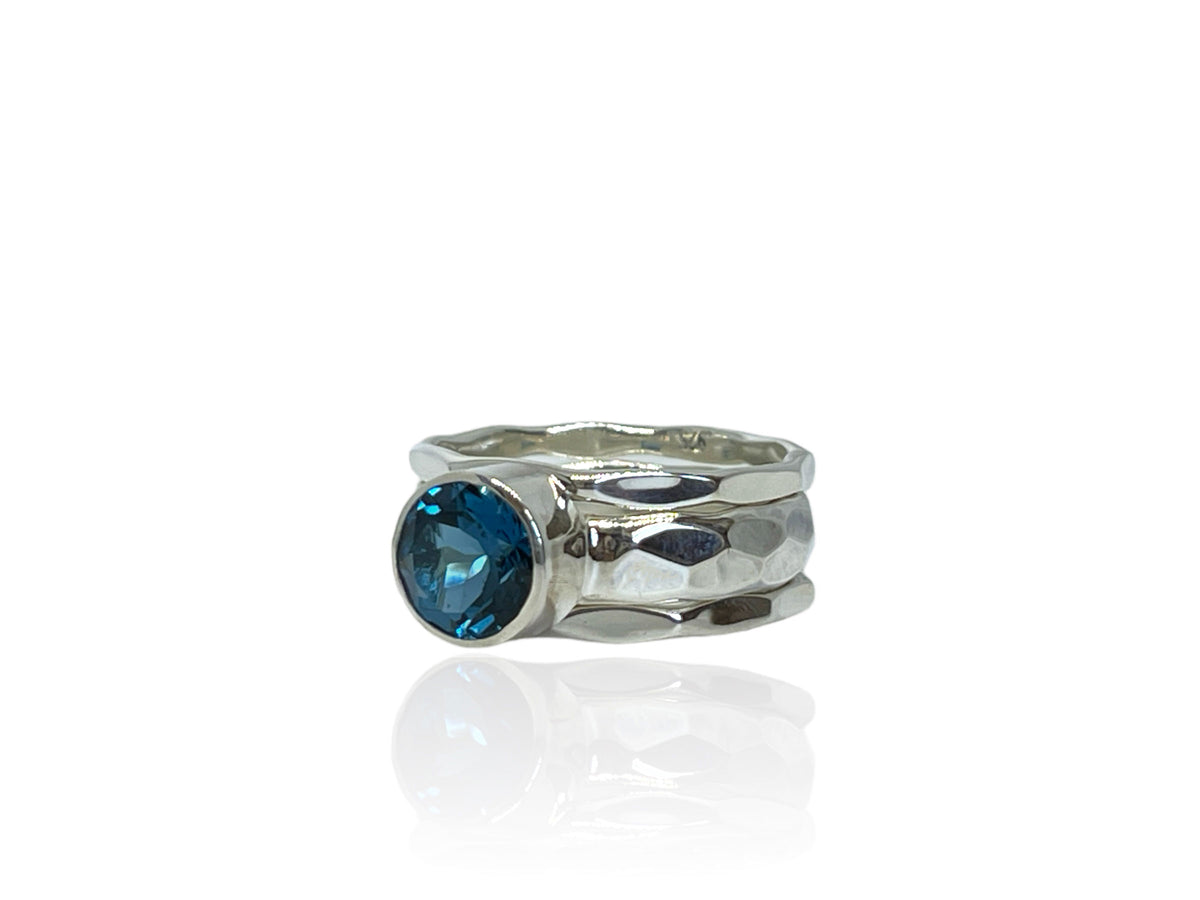 Side view of the wide hammered silver London blue topaz ring