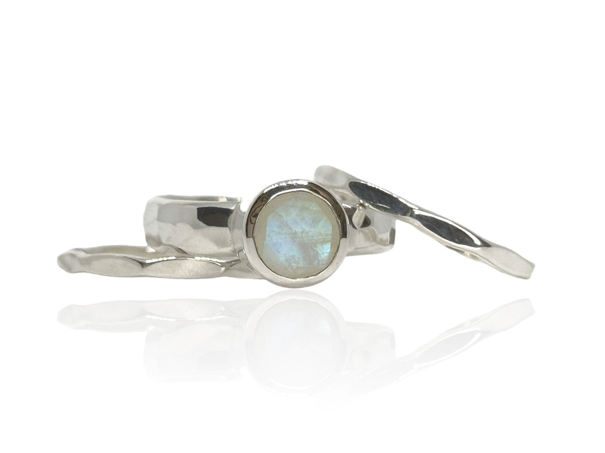8mm round faceted rainbow moonstone on a wide hammered sterling silver band with matching stack bands