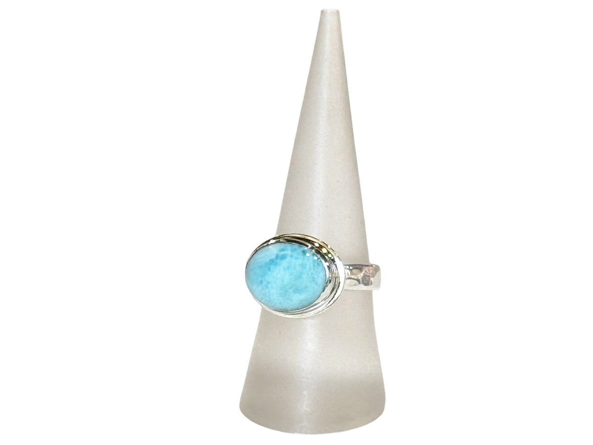 Close-up of the variegated blue larimar in its silver bezel