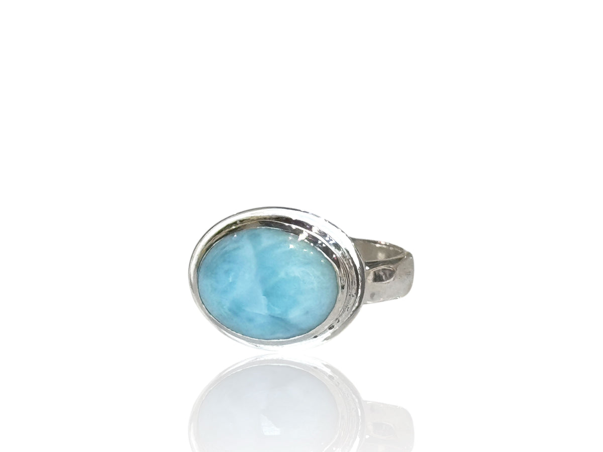 Side view of the oval larimar ring on its 4mm hammered silver band