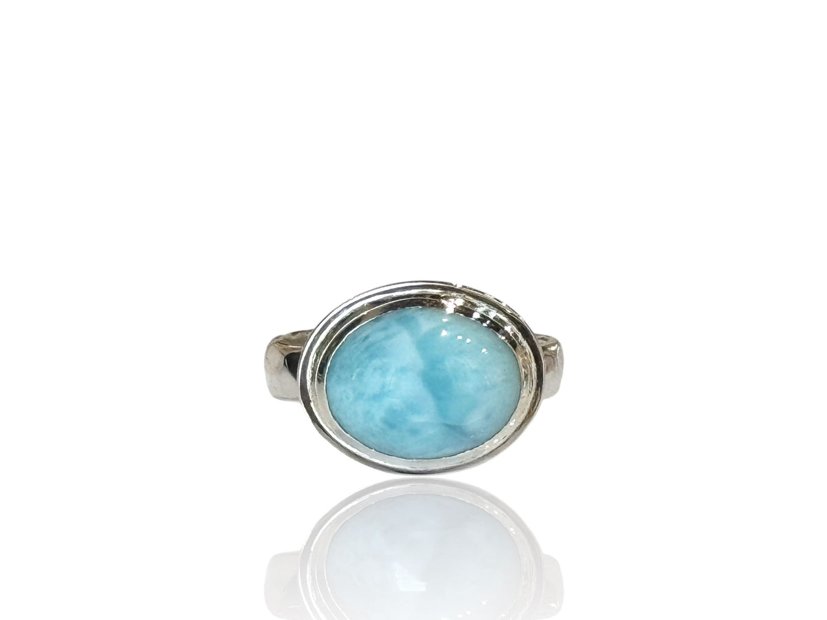 Oval Caribbean larimar cabochon set sideways in a polished bezel on a hammered silver band, size 9