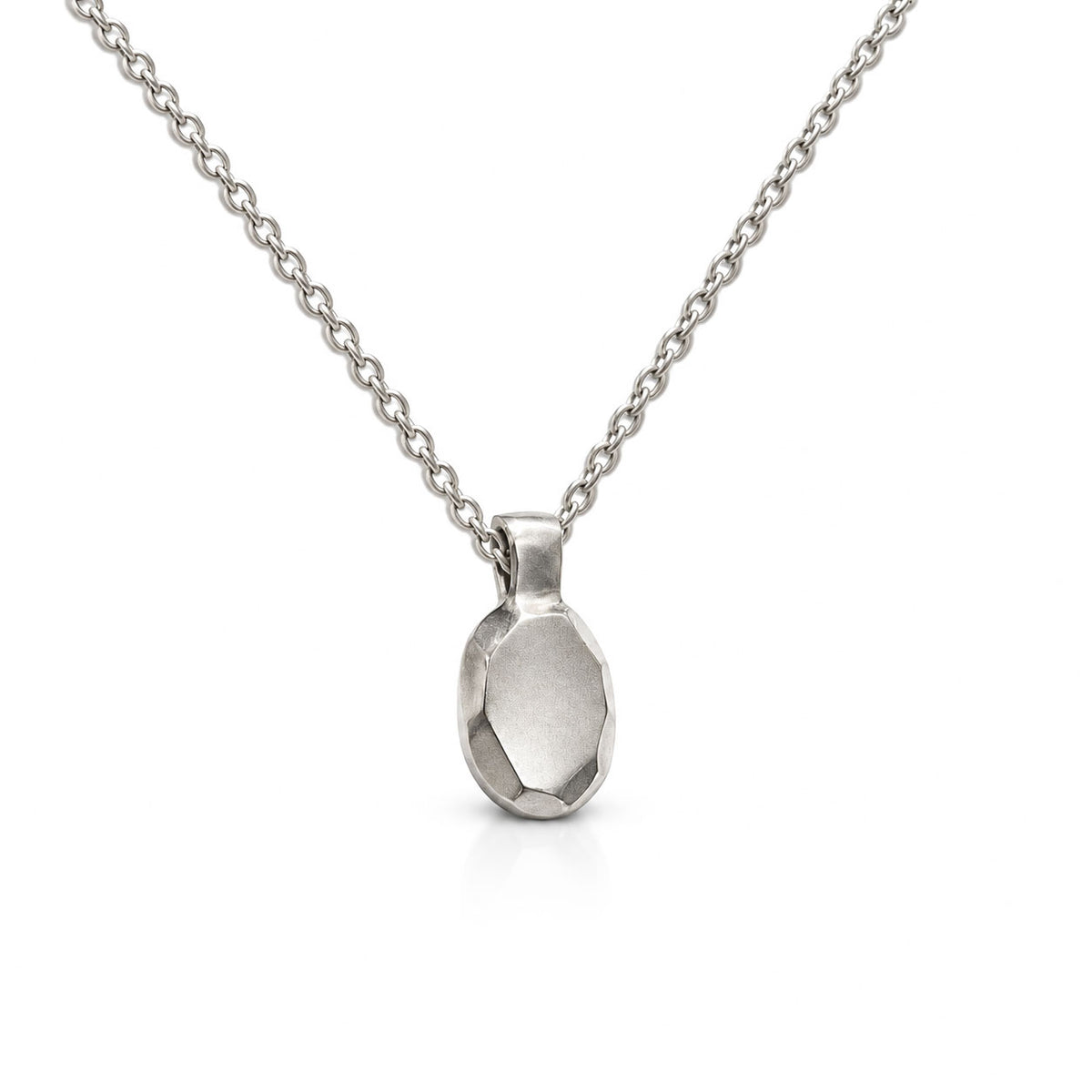Sterling silver pendant sculpted like an oval faceted gem with brushed facets, on a delicate cable chain