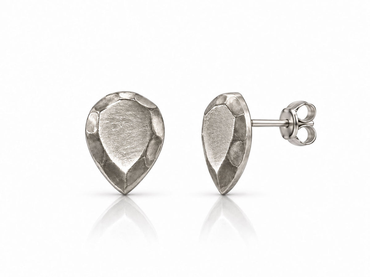 Sterling silver stud earrings sculpted like pear-shaped faceted gems with brushed facets