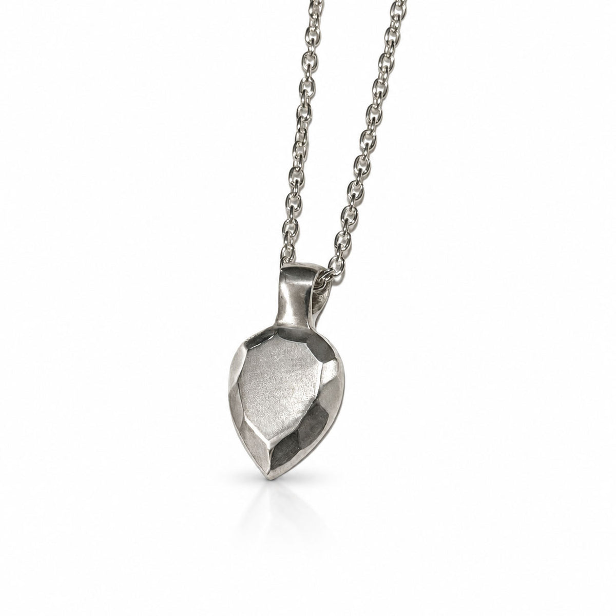 Sterling silver pendant sculpted like a pear-shaped faceted gem with brushed facets, on a delicate cable chain