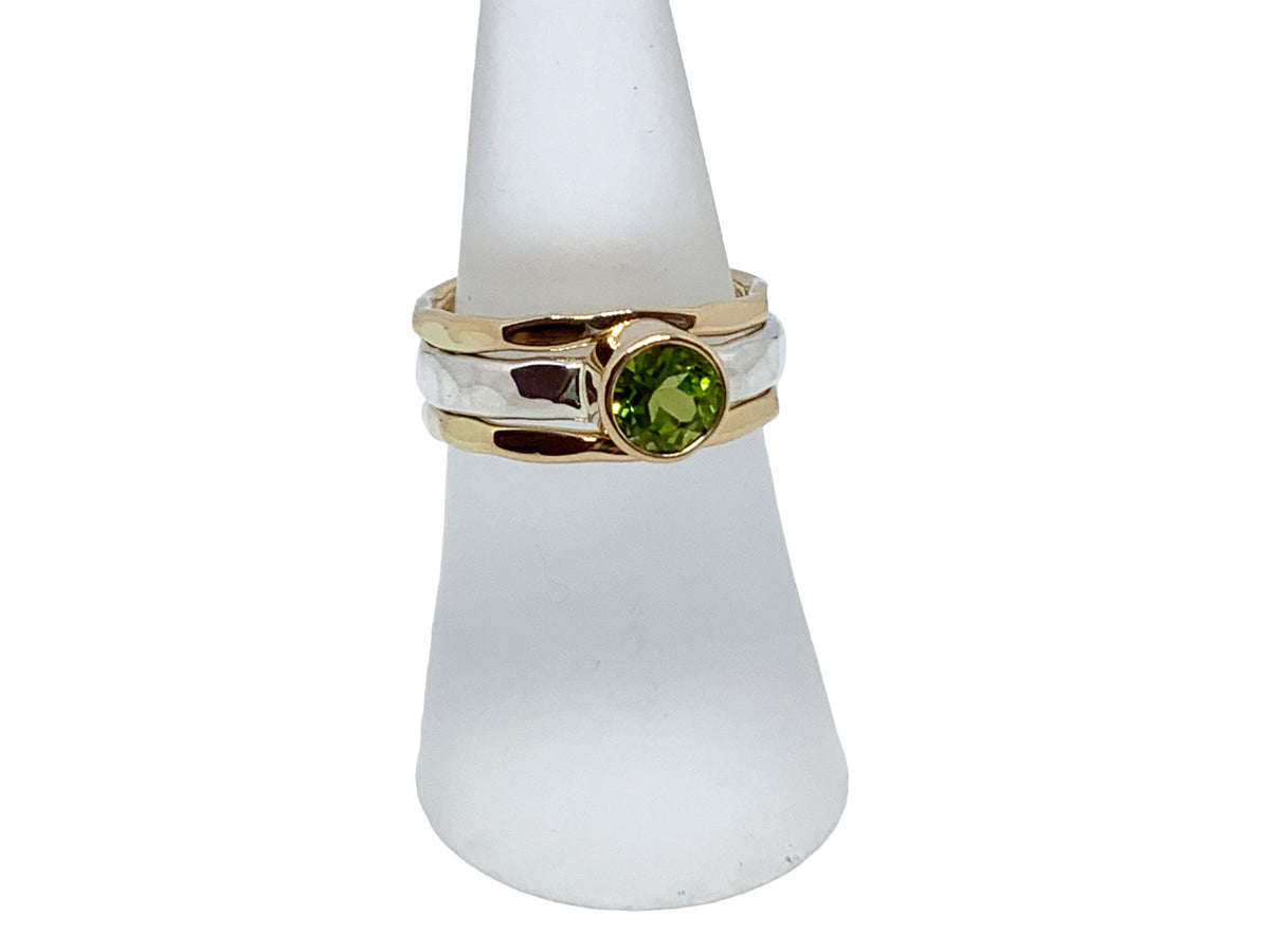 Close-up of the bright green peridot in its gold setting