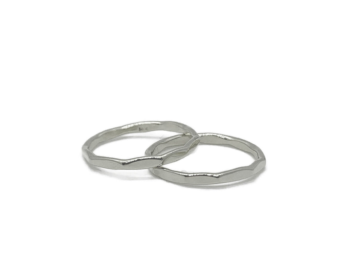 Set of two hammered sterling silver stack bands with a mirror finish