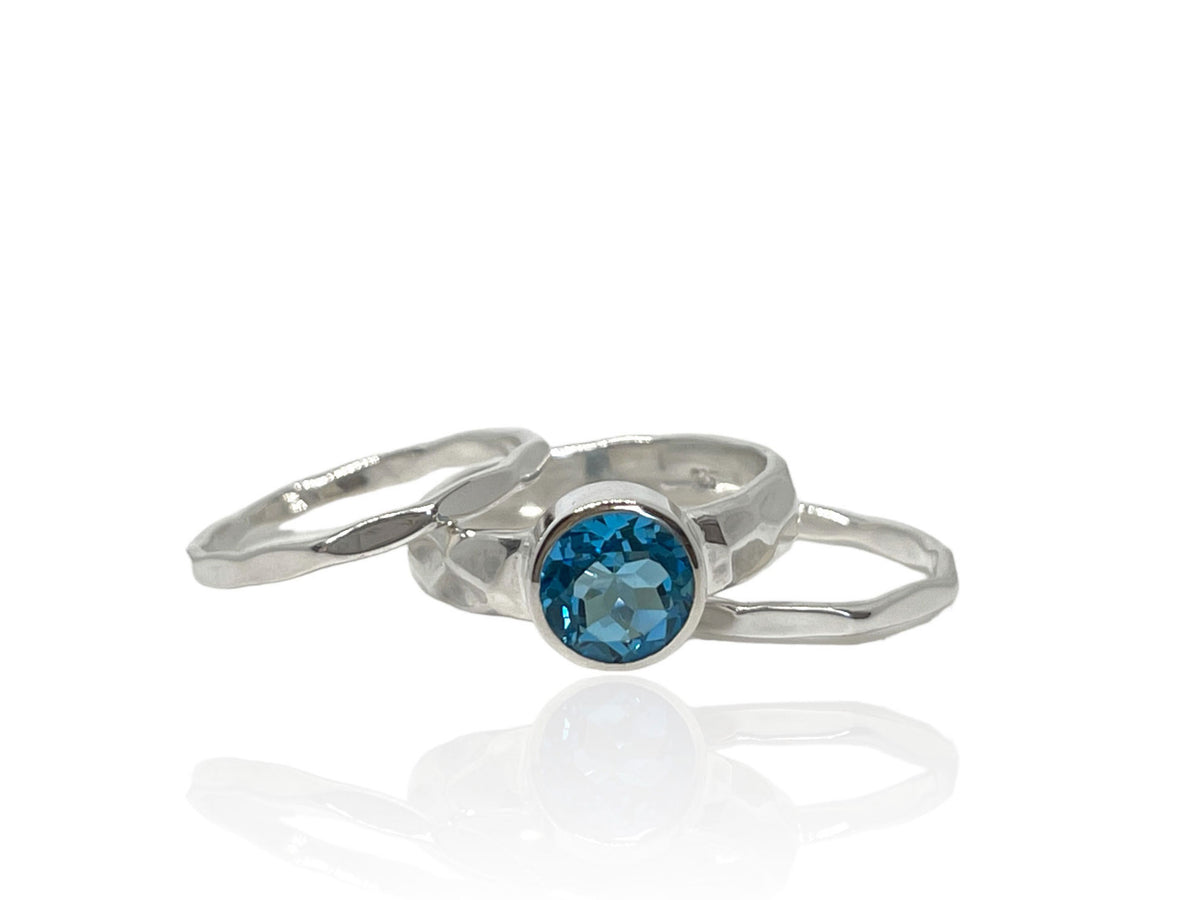 Another angle of the 2.50-carat blue topaz ring with silver stack bands