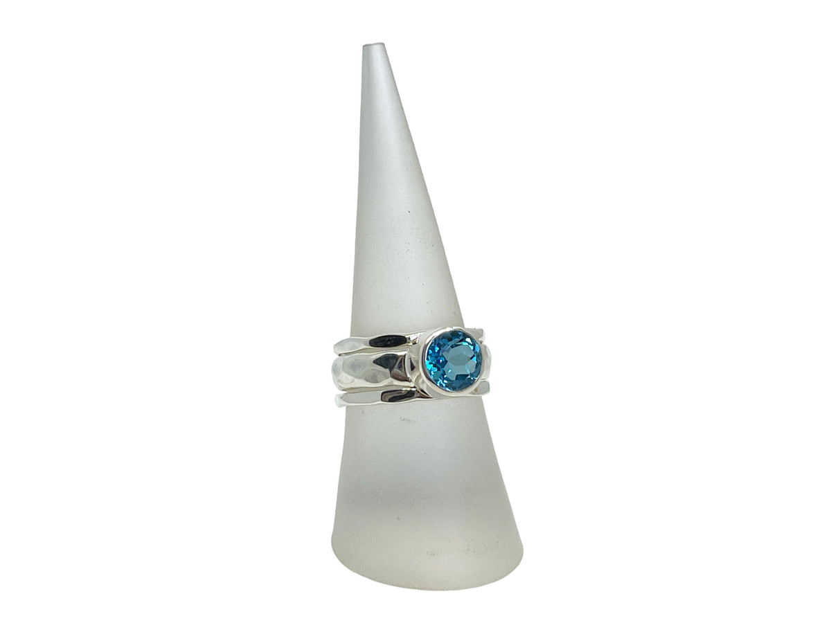 Side view of the wide hammered silver blue topaz ring