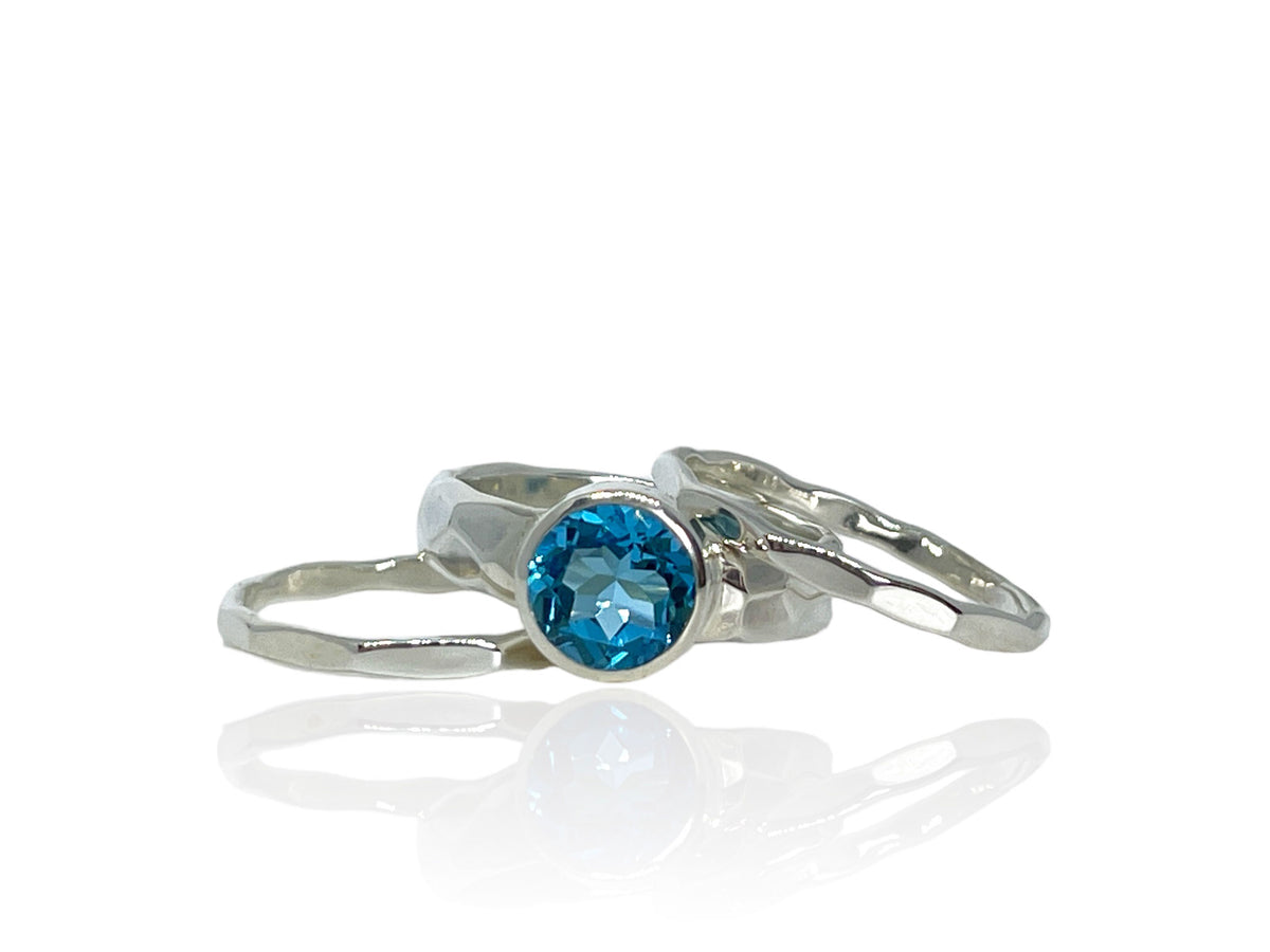 2.50-carat Swiss blue topaz on a wide hammered sterling silver band with matching stack bands