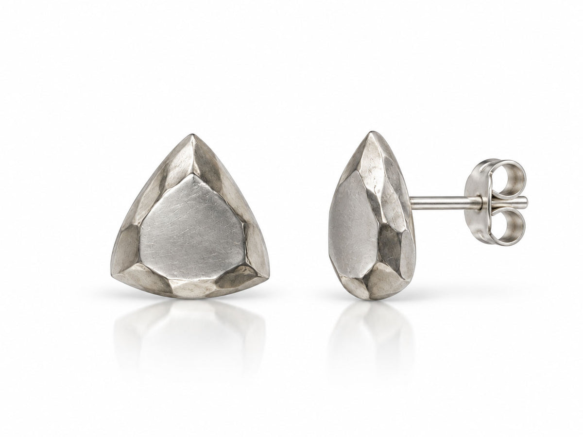 Sterling silver stud earrings sculpted like trillion-cut faceted gems with brushed facets