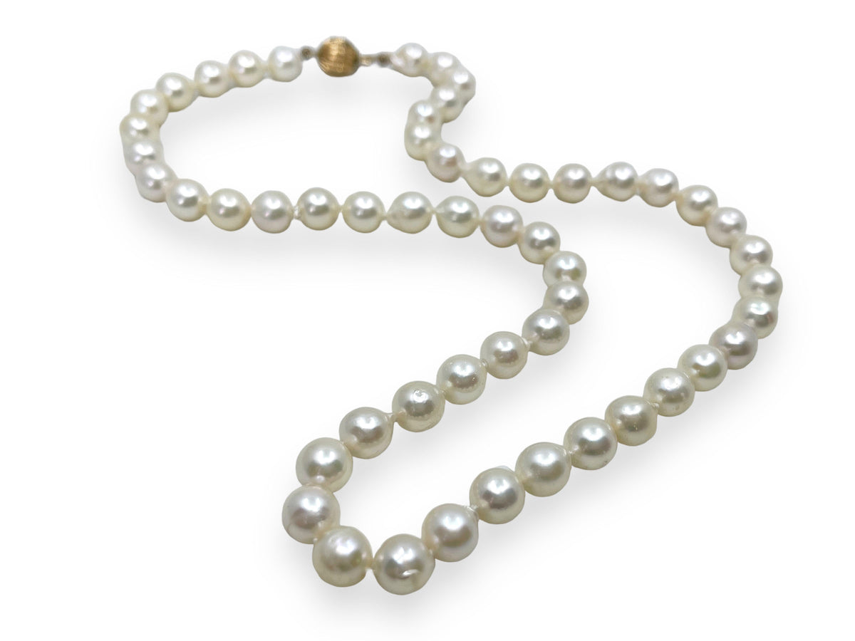Strand of white saltwater cultured baroque pearls with a near-round organic shape
