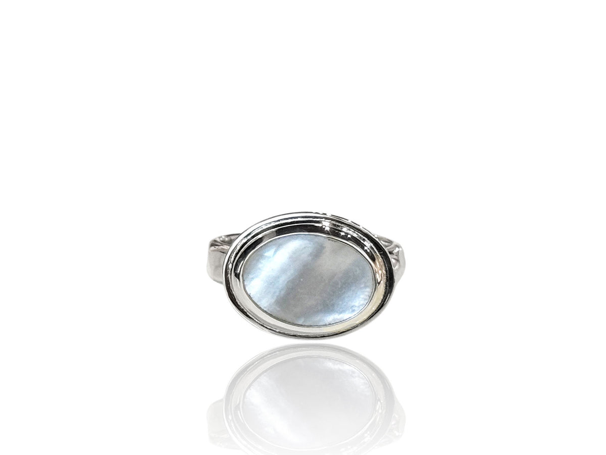 Side-set white oval mother-of-pearl in a textured, polished sterling silver bezel ring