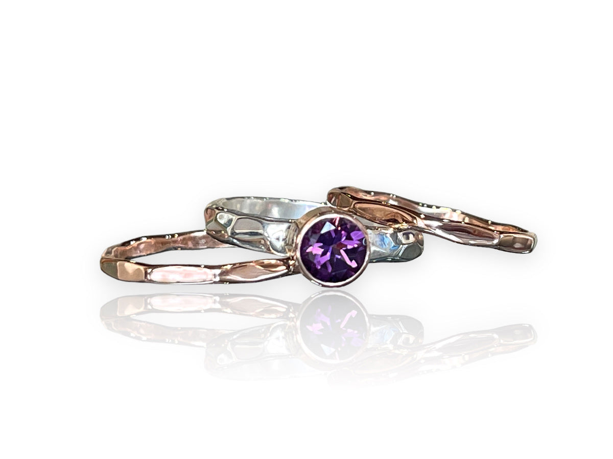 Deep purple amethyst in a 14kt rose gold bezel on a hammered sterling silver stack ring set