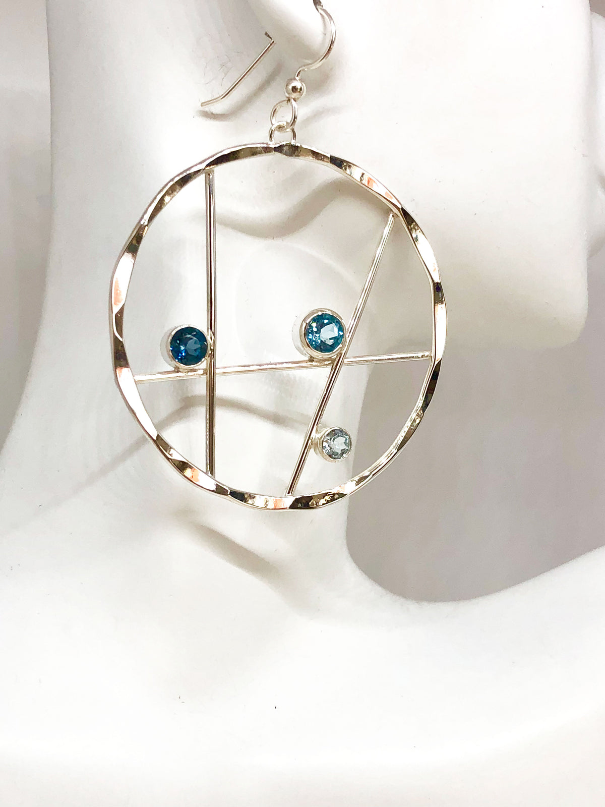 Side view of the blue topaz hammered silver hoop earrings