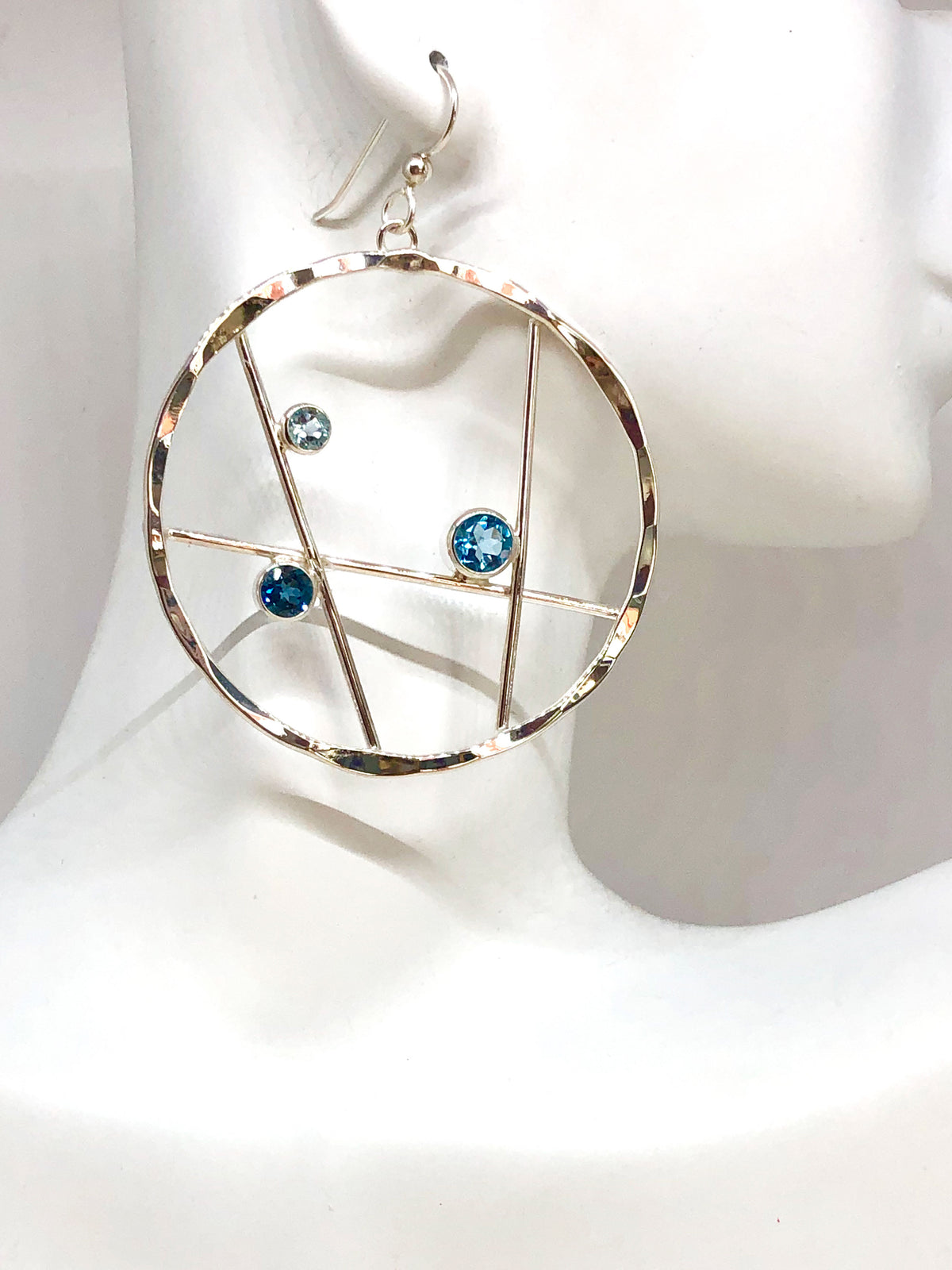 Another angle of the Caribbean blue topaz hoop earrings in sterling silver