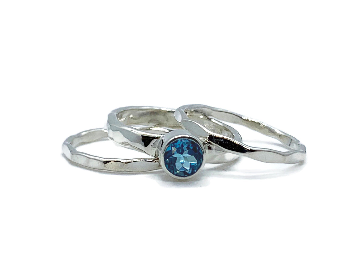 Swiss blue topaz on a hammered sterling silver ring with two silver stack accent bands