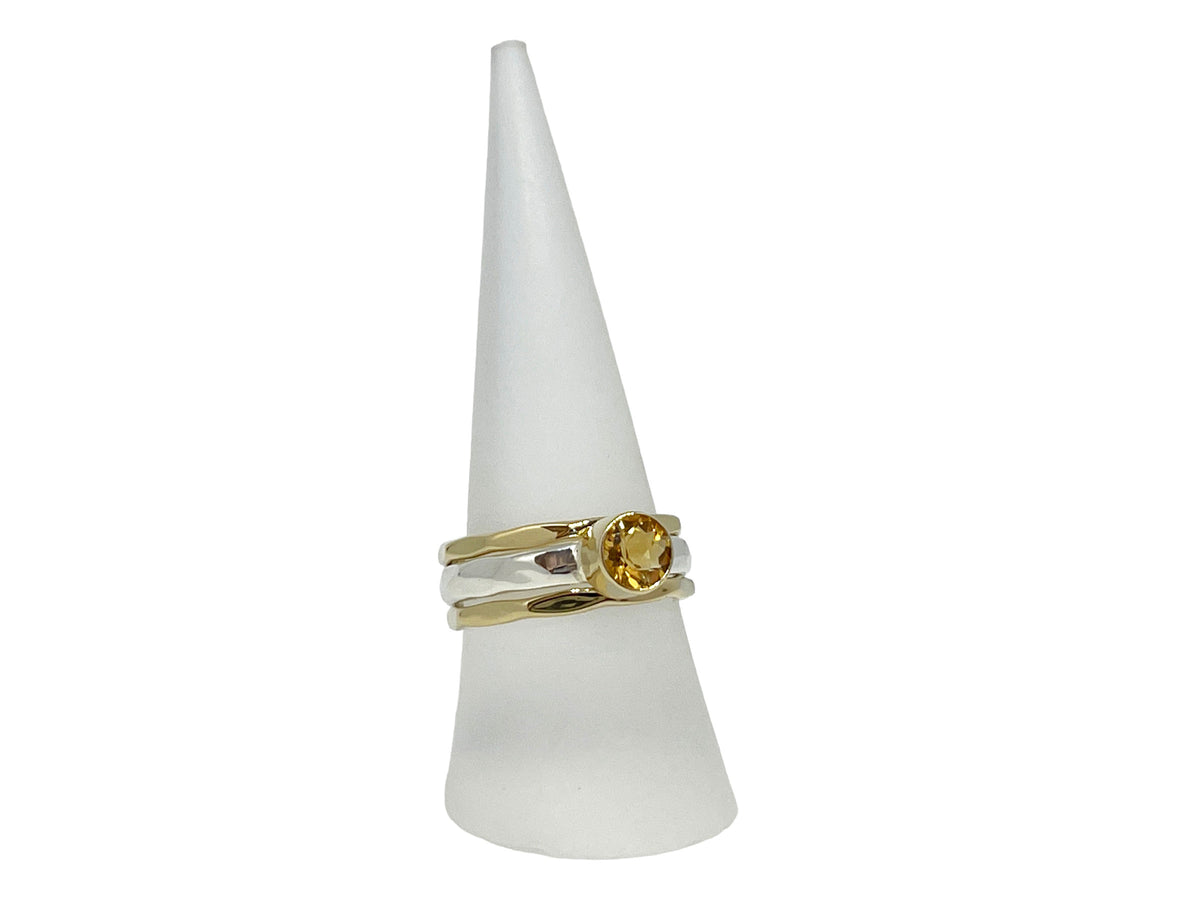 Close-up of the sunny faceted citrine in its yellow gold setting