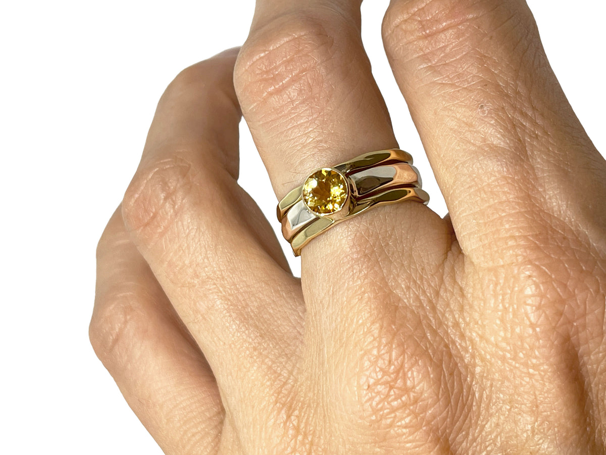Another angle of the citrine ring with silver and gold stack bands