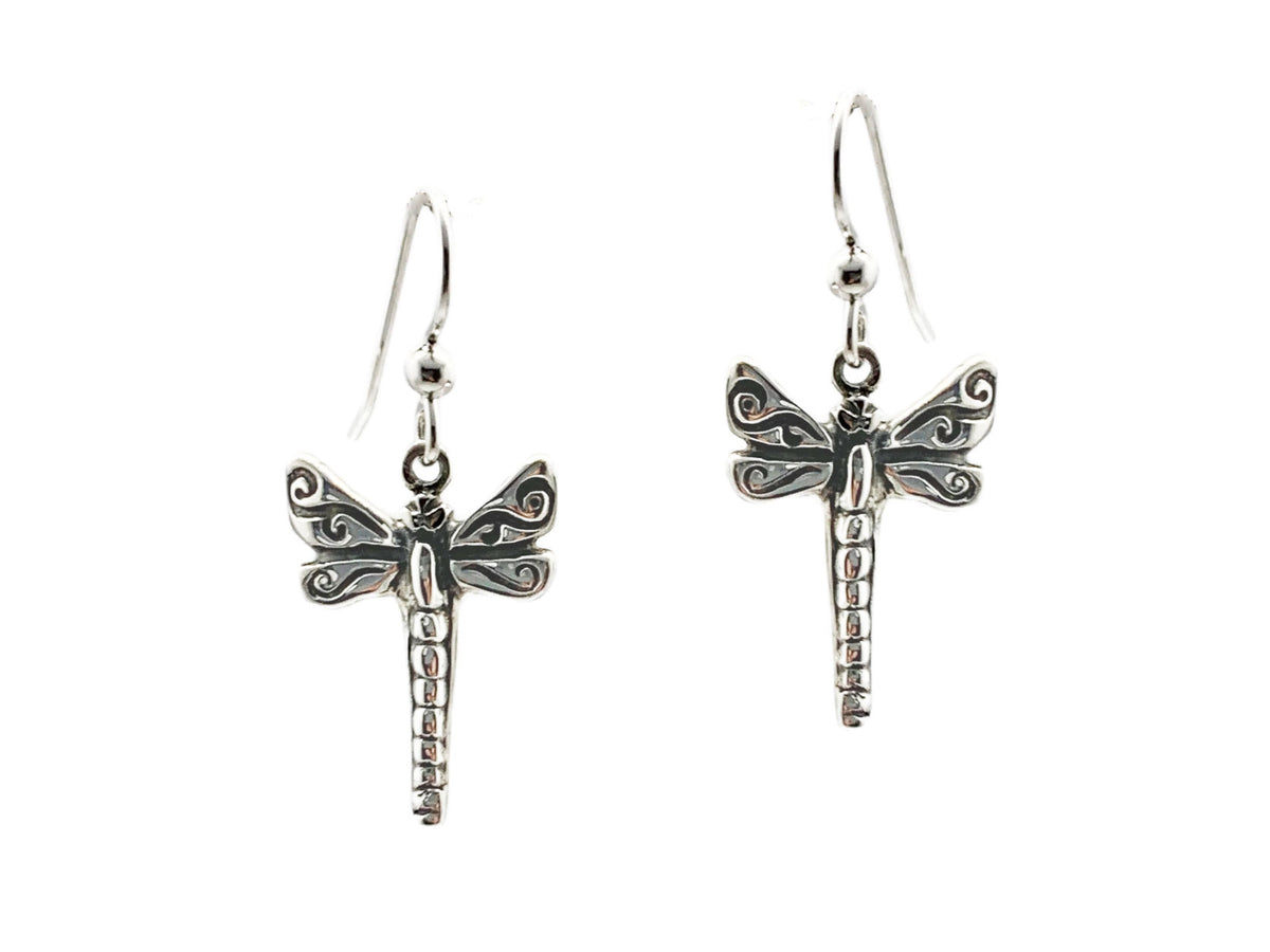 Sterling silver dragonfly earrings with oxidized swirl details on the wings, on French ear wires