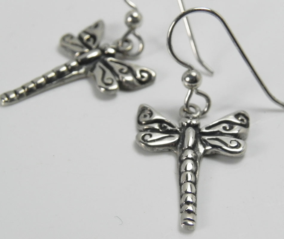 Silver dragonfly earring with swirl-patterned wings and French ear wire, another angle