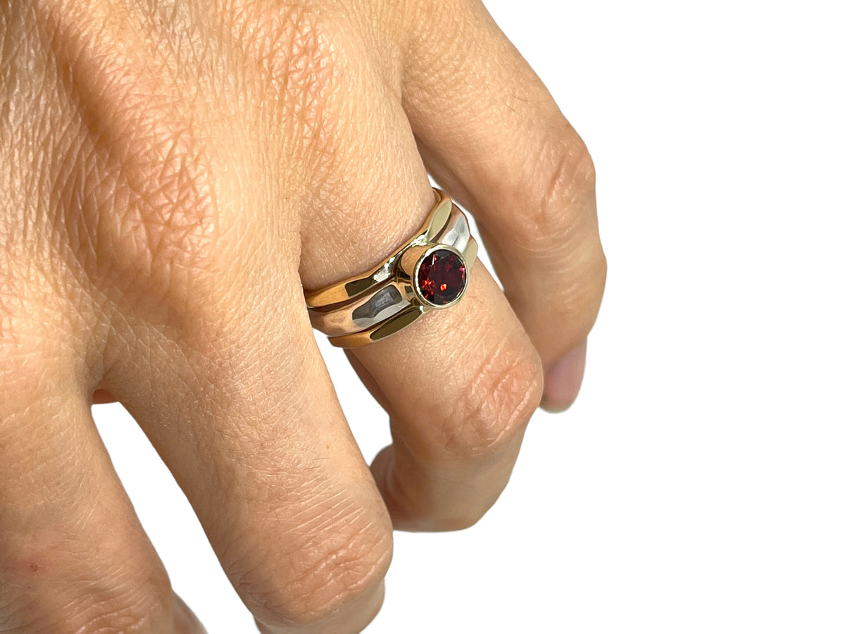 Close-up of the rich red garnet in its yellow gold setting