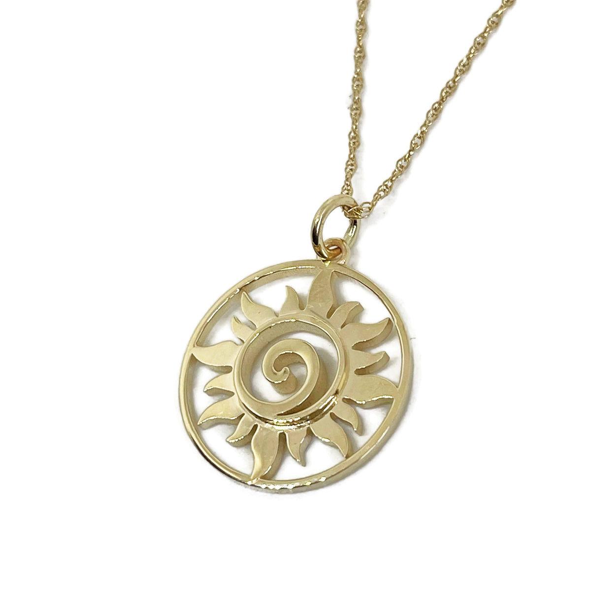 Small gold sun medallion necklace on its chain