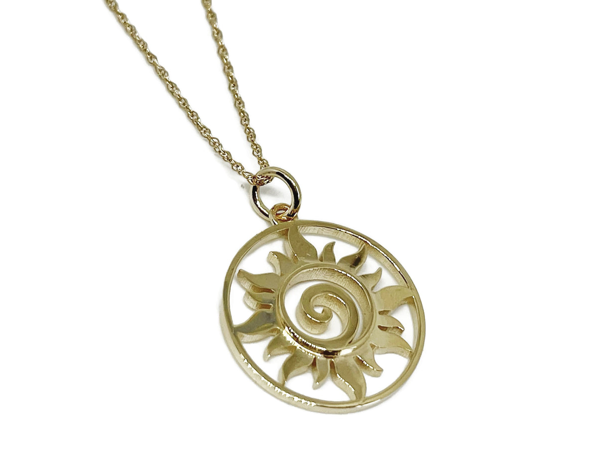 Close-up of the spiral center of the small gold sun medallion