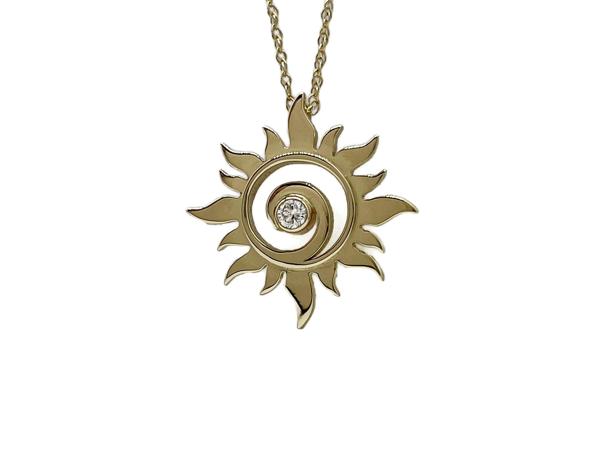 Gold sun swirl pendant with diamond on its chain