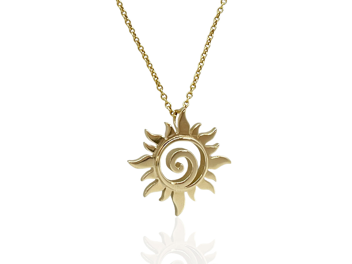 Yellow gold sun swirl pendant necklace with swirling rays around the center
