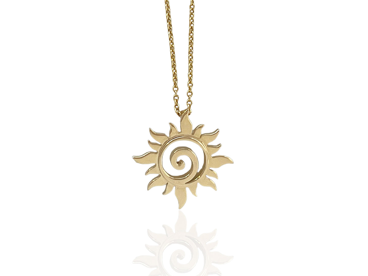 Close-up of the shining yellow gold sun swirl design