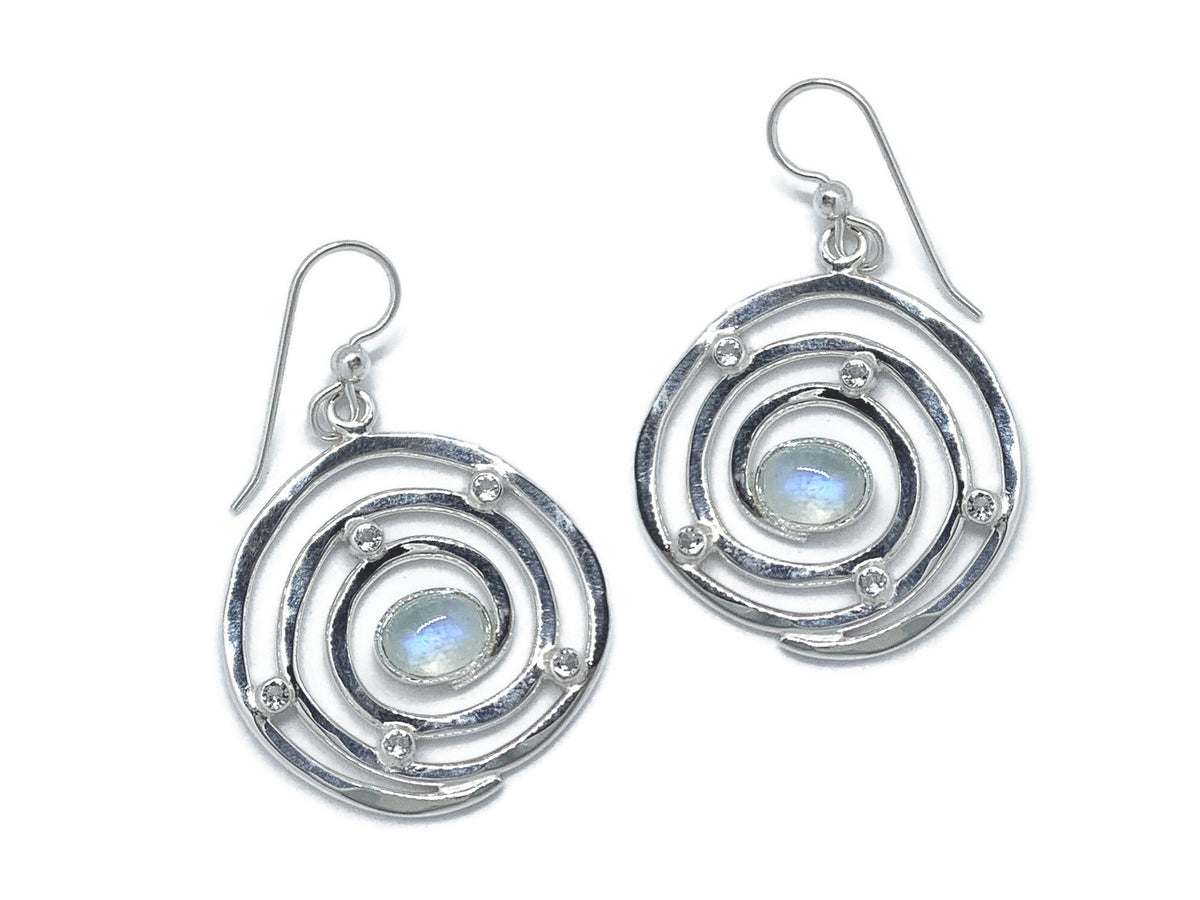 Hurricane-inspired Eye of the Storm earrings in sterling silver with a calm moonstone at the center of each swirl