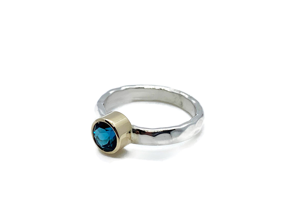 Close-up of the London blue topaz in its yellow gold setting