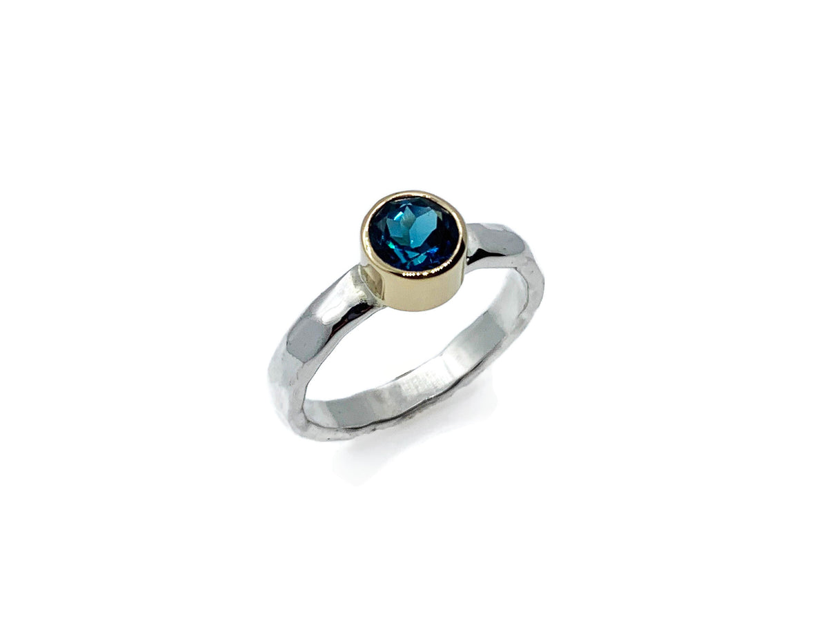 Another angle of the London blue topaz ring with gold and silver bands