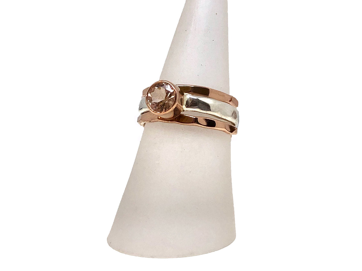 Side view of the rose gold morganite ring with its silver stack bands
