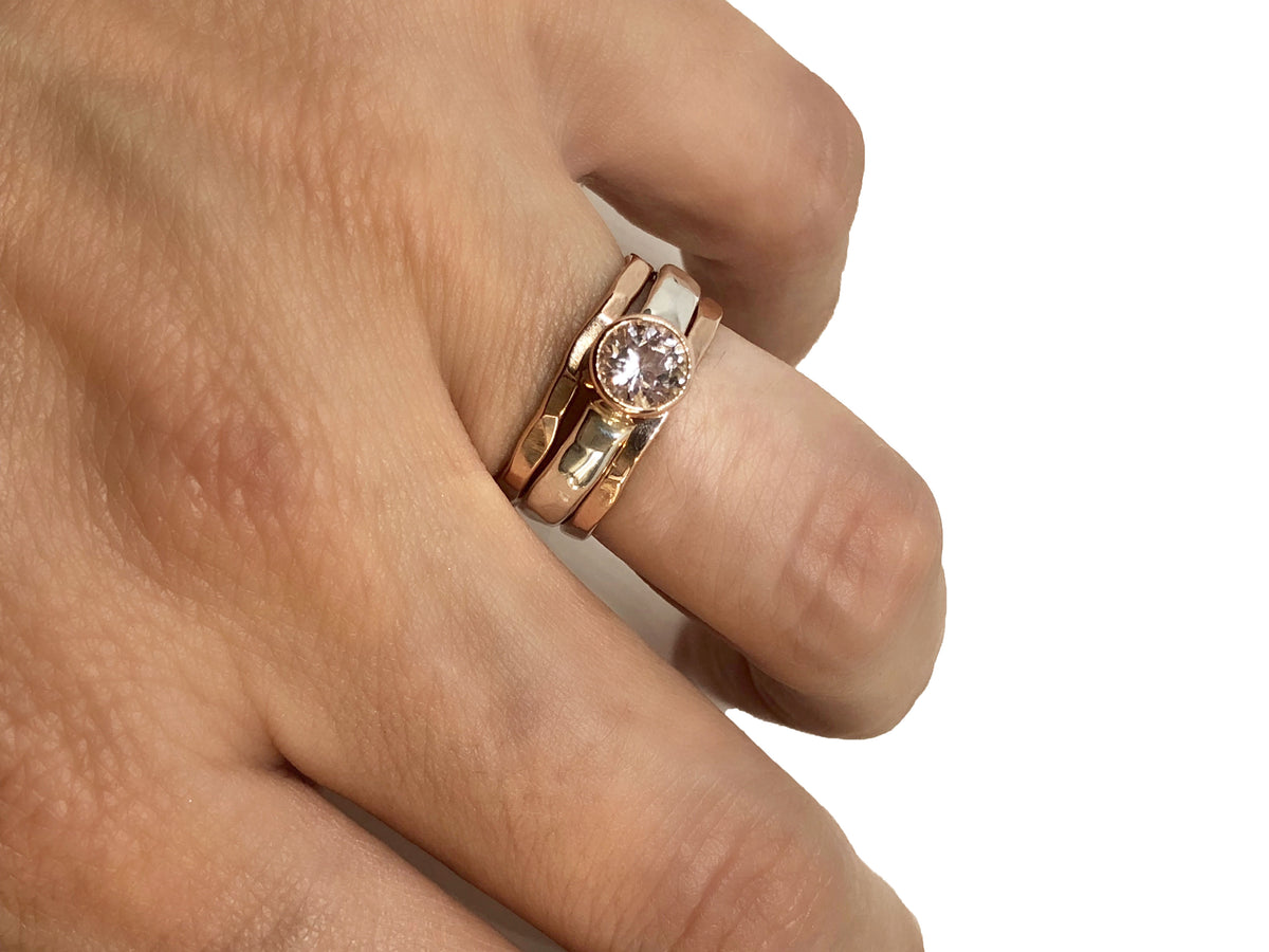 Close-up of the faceted morganite's soft peach-pink color in a rose gold setting