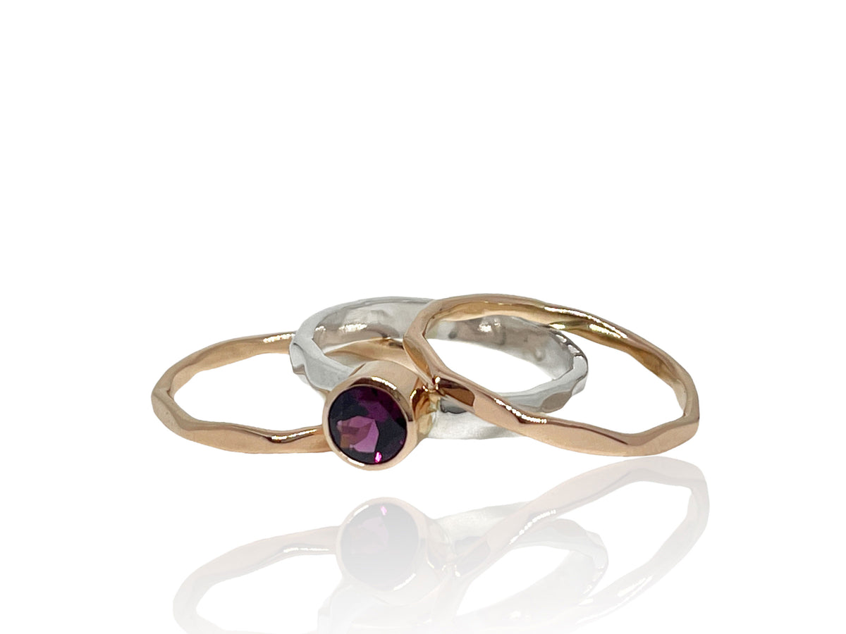 Close-up of the deep raspberry rhodolite garnet in its rose gold setting