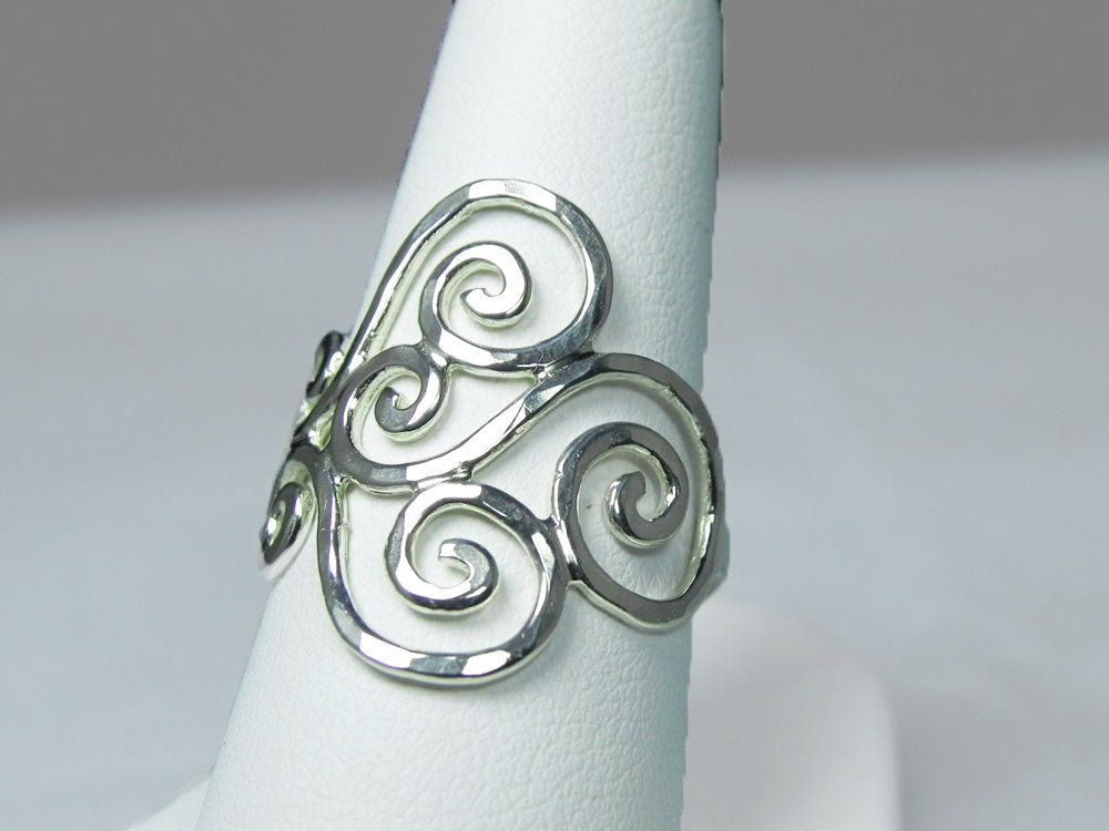 Close-up of the shimmering hammered texture on the silver swirl ring