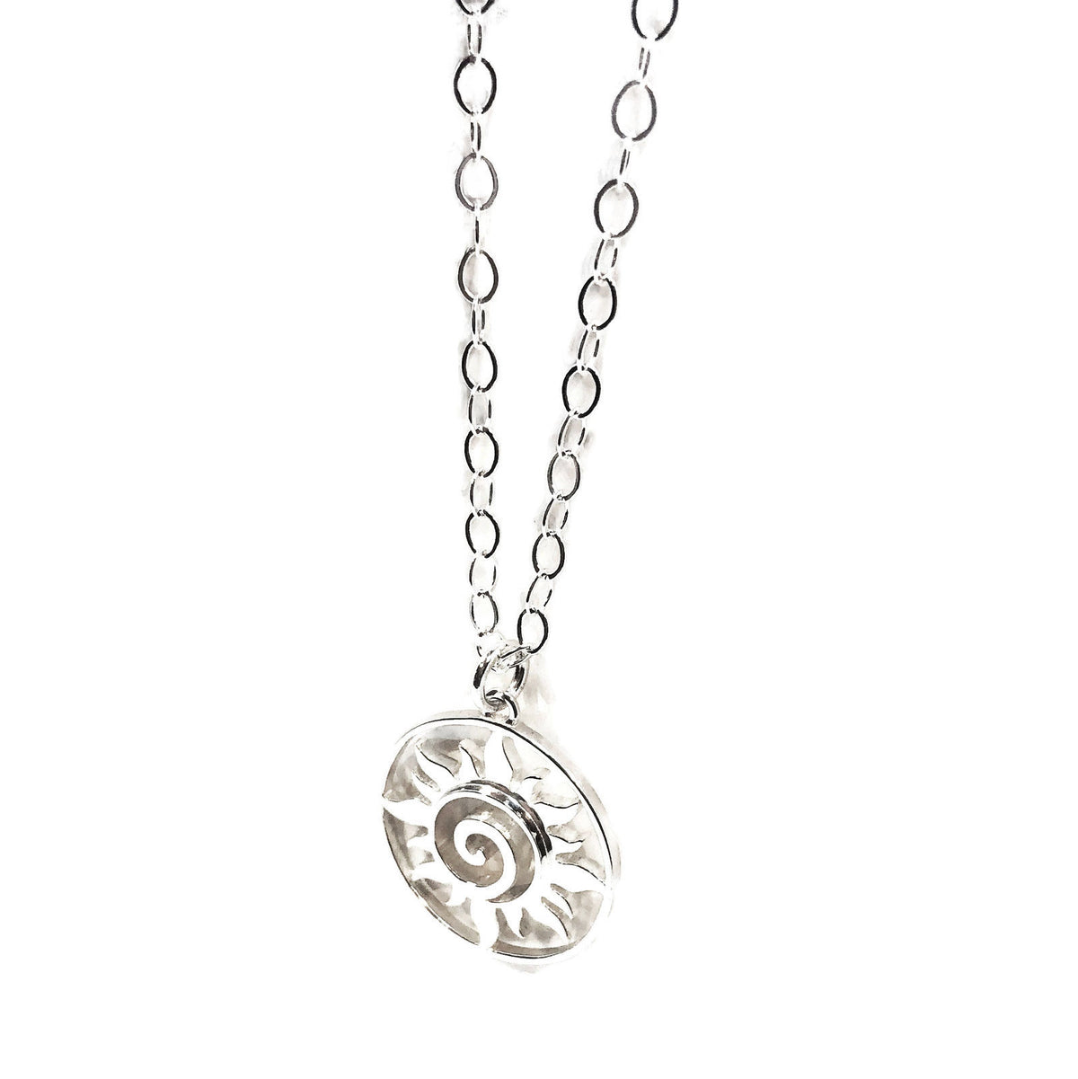 Close-up of the swirling rays inside the silver sun medallion