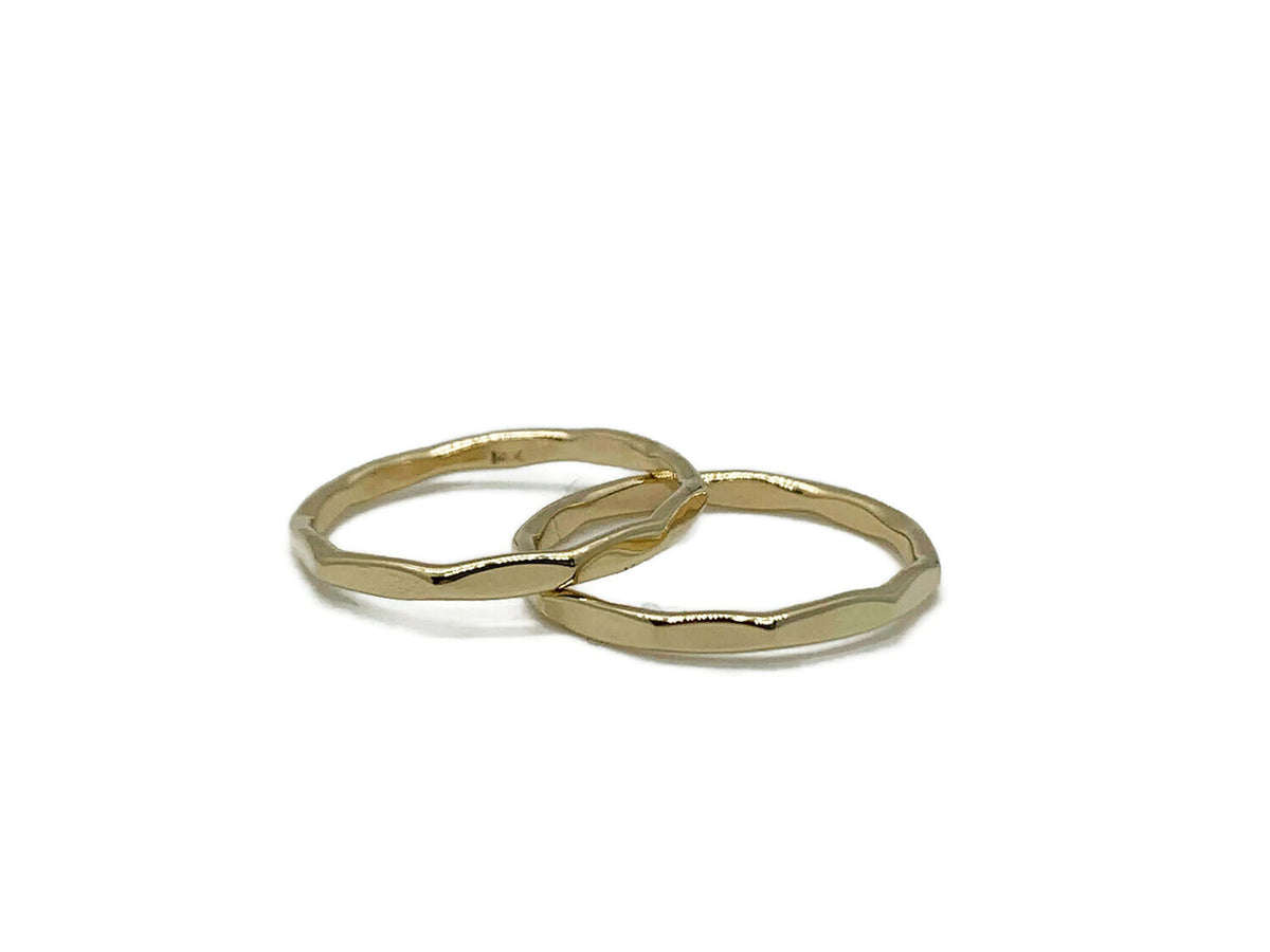 Set of two hammered 14kt yellow gold stack bands with a mirror finish
