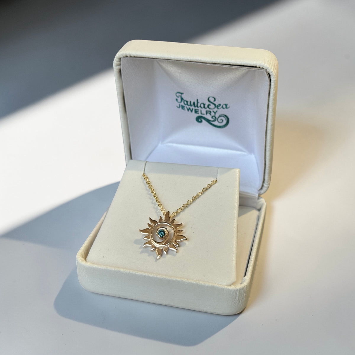 Gold Sun Swirl Pendant with Blue Diamond