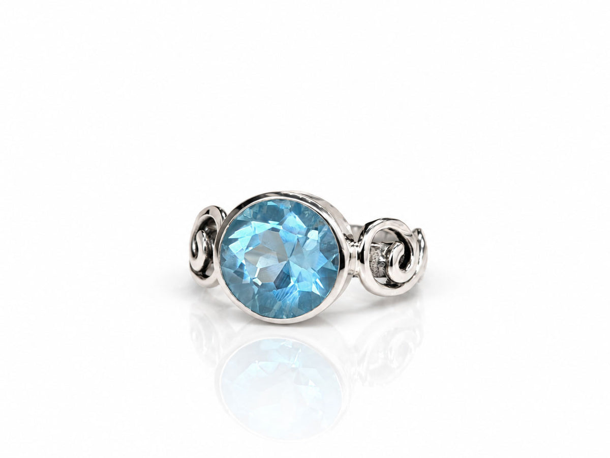 Silver Swirl Ring with Large Bezel Set Blue Topaz